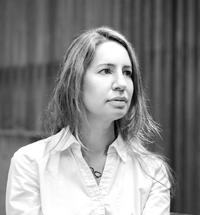 Latina woman with brown hair wearing a white shirt.