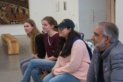 Students observe paintings from the Slow Reading, Slow Seeing exhibit.