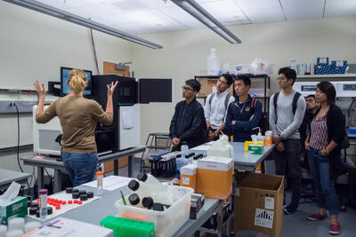 Director Shana McDevitt explains the Illumina sequencing device to Berkeley Connect students.